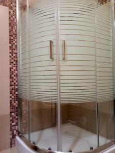 a shower with a glass door in a bathroom at Plakoudis Rooms in Stavros +55 photos