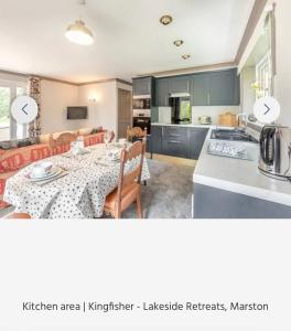 a kitchen and living room with a table and a kitchen and a kitchenkeeper javascript at Kingfisher Lodge in Grantham