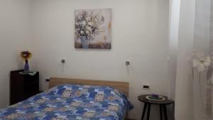 a bedroom with a bed with a blue quilt on it at APARTMAN ROSEMARY in Rijeka