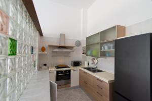 a kitchen with a black refrigerator and a sink at Dimora Azzurra in Pezze di Greco +19 photos