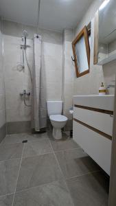 a bathroom with a toilet and a shower at Apartment DEVA in Balchik