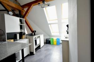 a kitchen with white cabinets and a stove top oven at frigg flats I Industrial Style I Loft I Billard I in Landshut