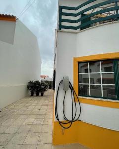 a hose is attached to the side of a building at Comporta Centro Villa 3 quartos MHouse lease in Comporta