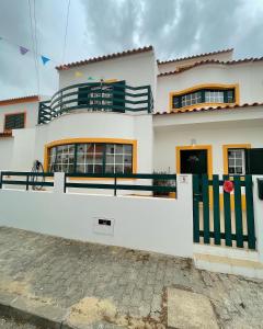 a white house with a fence in front of it at Comporta Centro Villa 3 quartos MHouse lease in Comporta