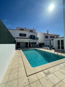 a swimming pool in front of a building at MHouse lease Comporta Nature Retreat 3BR Villa in Comporta