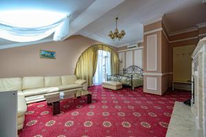 a living room with a couch and a table at Gostiniy Dvor in Odesa