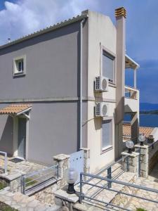 una casa bianca con balcone e un edificio di Sunrise guest house a Nydri