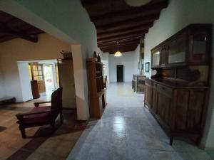 a large kitchen with a couch and a chair in a room at Quinta La Martita in Ingeniero Giagnoni