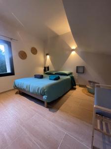 a bedroom with a large bed in a room at Mas du Couchant in Suze-la-Rousse