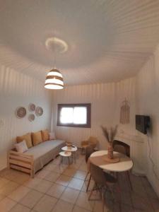 a living room with a bed and a table at Studio 'Katerina by the Sea' in Salamina