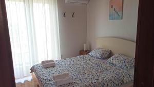 a bedroom with a bed with two pillows on it at Holiday Home Family - 100m from sea in Vantačići