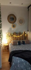 a bedroom with a bed and mirrors on the wall at Studio confort #3, Proche Gare et commodités in Maubeuge