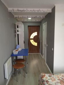 ヴェルホヴィナにあるPidkovaの青いテーブルと椅子、ドアが備わる客室です。