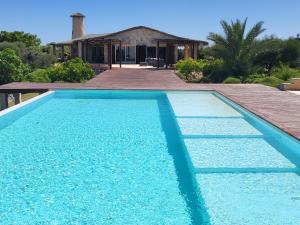 a swimming pool in front of a house at Villa Claire in Toliara