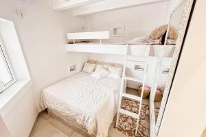 um pequeno quarto com uma cama e um espelho em Luxury House 80m2 Terrace em Cala Morell