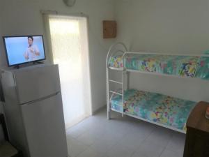 a bedroom with a bunk bed and a tv on a dresser at Ervilia in Vieste