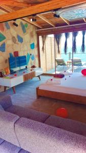 a room with two beds and a stone wall at Mandalina Suites in Kaş