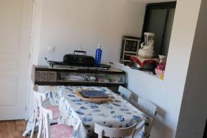 a dining room with a table with chairs and a tableablish at Océane in Gujan-Mestras