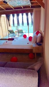 a bedroom with a large bed with a view of the ocean at Mandalina Suites in Kaş