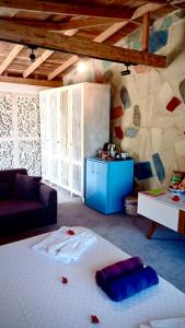 a room with a large white bed in front of a stone wall at Mandalina Suites in Kaş