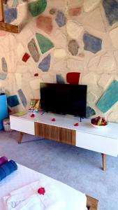 a white table with a tv on top of it at Mandalina Suites in Kaş