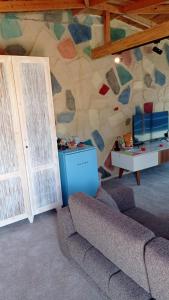 a living room with a couch and a stone wall at Mandalina Suites in Kaş
