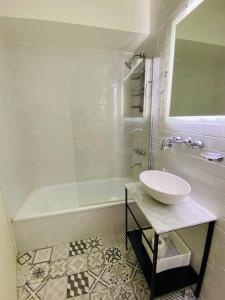 Baño blanco con lavabo y bañera en Depto de lujo con pileta en San Telmo en Buenos Aires