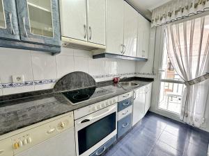 a kitchen with white cabinets and a sink at Isla Mar - 5833 in Isla