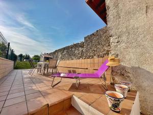 a purple chair sitting on top of a patio at A Babor - 20805 in Argoños