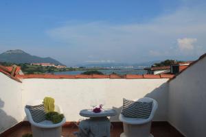 a balcony with two chairs and a table with a view at A Babor - 20805 in Argoños