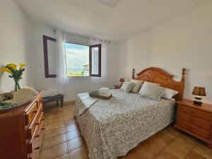 a bedroom with a large bed and a window at A Babor - 20805 in Argoños