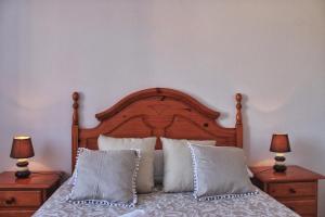 a bedroom with a bed with pillows and two lamps at A Babor - 20805 in Argoños +31 photos