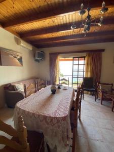 a dining room with a table and a living room at Emilios see view Apartment in Barbati +49 photos