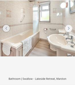 a bathroom with a sink and a tub and a toilet at Swallow lodge in Lincolnshire