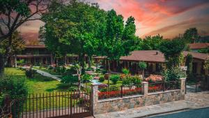 a house with a fence in front of a garden at SIMI Luxury Suites in Plaka Litochorou