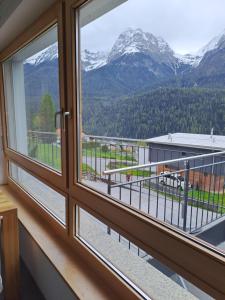 a window with a view of a mountain at Chasa Azura in Scuol