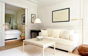 a living room with a white couch and a bed at Grand-Hôtel du Cap-Ferrat, A Four Seasons Hotel in Saint-Jean-Cap-Ferrat