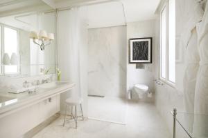 a white bathroom with a sink and a toilet at Grand-Hôtel du Cap-Ferrat, A Four Seasons Hotel in Saint-Jean-Cap-Ferrat
