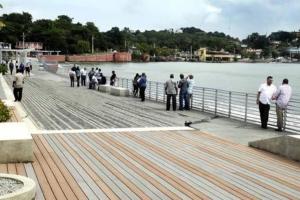 a group of people standing on a pier near the water at Villa Orquidea 1 in Humacao