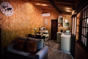 a living room with a couch and a kitchen at Quinta da Mal-disposta, cabin lodge Countryhouse in Resende