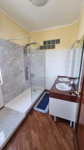 a bathroom with a shower and a sink at Petronia Home in Porto Torres