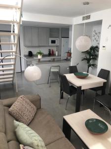a living room with a couch and a table and a kitchen at El Islote de Terreros in San Juan de los Terreros