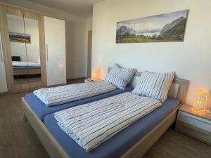 a bedroom with two beds and a painting on the wall at Wohnung 13 in Wildeshausen