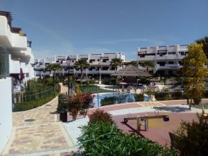 a view of a resort with a pool and buildings at El Islote de Terreros in San Juan de los Terreros
