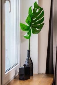 a vase with a plant in it on a table at Modern&Cozy Garbary Apartment with Parking and Balcony by Renters in Poznań