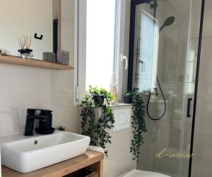 a bathroom with a sink and a shower with plants at Mobile home d-view in Drage