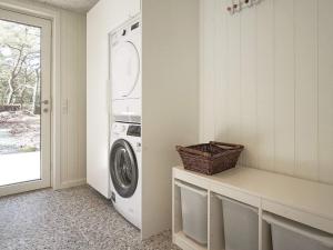a white laundry room with a washer and dryer at Holiday home Nexø XLI in Vester Sømarken