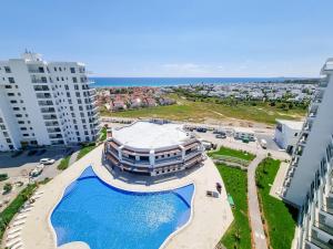 an aerial view of a building with a swimming pool at Holiday Stay with Aqua Park in Isabella, Caesar Blue Resort, Lunch till 4pm, SPA, Gym and Kids Club in Kalecik