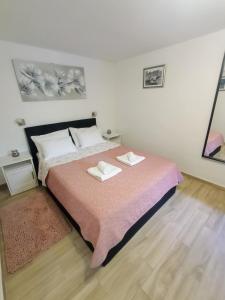 a bedroom with a bed with two towels on it at Apartments Ivica Split in Split