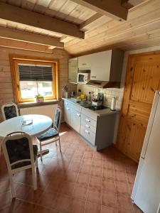 a kitchen with a table and chairs in a room at FeWo Wardersee in Rohlsdorf +2 photos